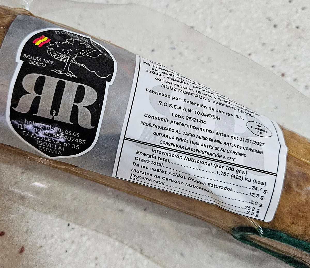 Etiqueta del salchichón cular ibérico de bellota RR: sello Bellota 100% Ibérico, ingredientes, alérgeno nuez moscada, lote, registro sanitario e información nutricional.